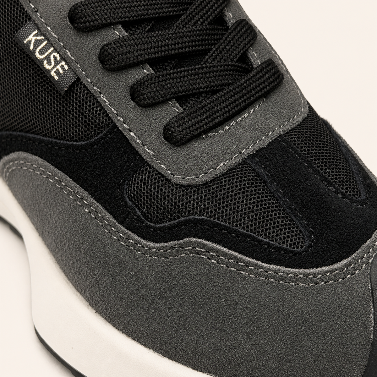 Vista detalle zapatillas Kuse negras unisex con cordones negros y diseño minimalista elegante